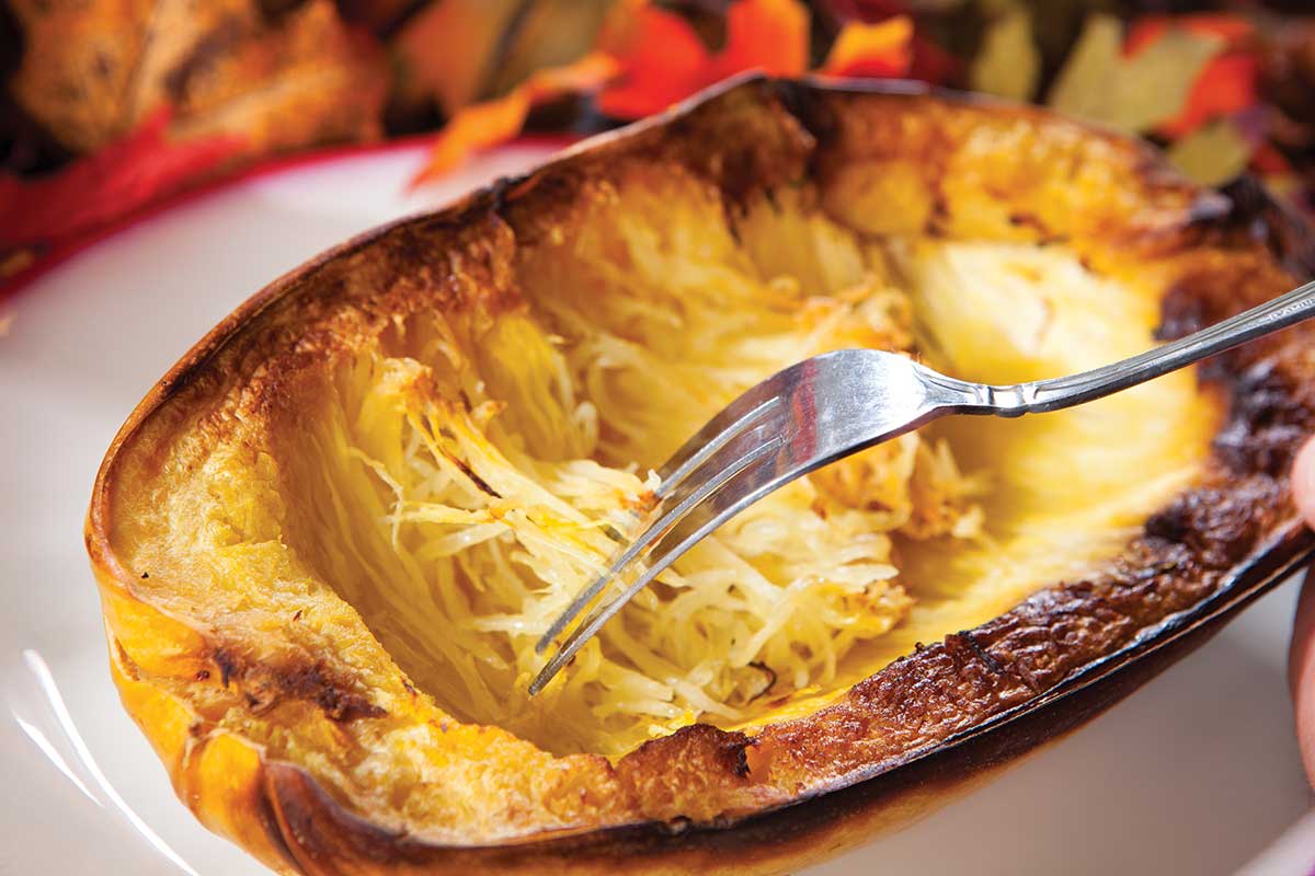 pulling apart spaghetti squash with a fork